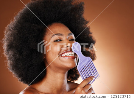 Curly hair, beauty comb and black woman, afro hairstyle and cosmetics of hair salon perm on studio background. Portrait happy african, hair brush and natural hair care, fashion and big hair style Curly hair, beauty comb and black woman, afro hairstyle and cosmetics of hair salon perm on studio background. Portrait happy african, hair brush and natural hair care, fashion and big hair style 125123715