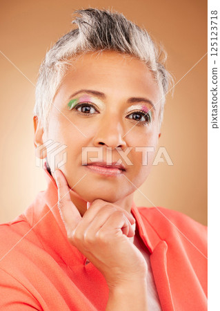 Makeup, creative and senior woman with fashion, beauty and designer luxury against a brown studio background. Stylish, retirement and portrait of elderly model with an idea for cosmetics and style Makeup, creative and senior woman with fashion, beauty and designer luxury against a brown studio background. Stylish, retirement and portrait of elderly model with an idea for cosmetics and style 125123718
