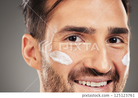 Face, man and cosmetics skincare for spa beauty product or skin healthcare wellness. Portrait, healthy facial care and model with luxury lotion for dermatology self care in grey background studio 125123761