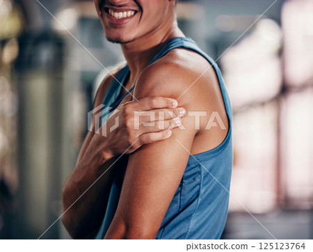 Sports injury, pain and arm massage at gym after accident during fitness training, exercise and workout with sore muscle or fibromyalgia. Man with orthopedic or arthritis problem at health club 125123764