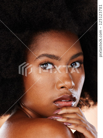 Skincare, beauty and black woman in studio for cosmetics, makeup and dermatology product or afro haircare. Portrait and face of African model with a glow and self love for health and wellness of skin Skincare, beauty and black woman in studio for cosmetics, makeup and dermatology product or afro haircare. Portrait and face of African model with a glow and self love for health and wellness of skin 125123781