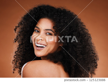 Black woman, beauty and haircare with portrait for curly hair, hair care and hairstyle on a brown studio background. Afro, african american woman and hair style or hair care for health and hair 125123886