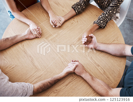 Business people holding hands in therapy group, team building or staff support with diversity, empathy and solidarity. Corporate circle hand holding on table above for prayer, trust and community 125123916