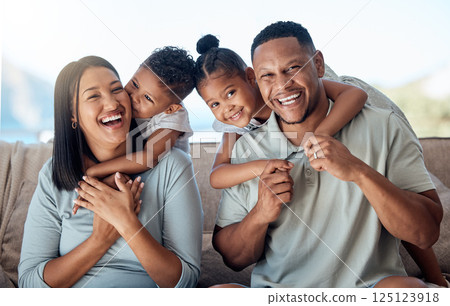Happy family, mother and father with children in a portrait in a sofa bonding hugging and laughing together. Mom, dad and fun Mexican kids playing, kissing parents and enjoying quality time in Mexico 125123918