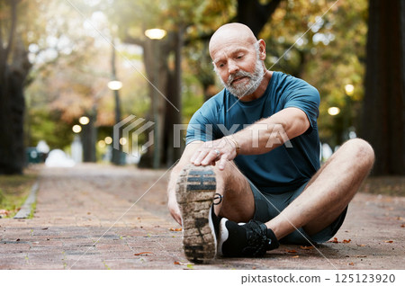 Fitness, exercise and senior man stretching legs at an outdoor park for energy, health and wellness during retirement. Healthy elderly male on ground for a warm up and cardio workout in nature Fitness, exercise and senior man stretching legs at an outdoor park for energy, health and wellness during retirement. Healthy elderly male on ground for a warm up and cardio workout in nature 125123920