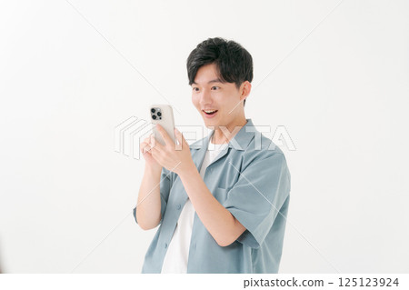A young man operating a smartphone A young man operating a smartphone 125123924