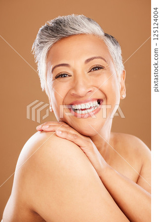 Skincare portrait, senior woman with happy smile and natural beauty cosmetics for luxury wellness. Face of indian lady, dermatology in makeup on brown studio background and healthy body positivity Skincare portrait, senior woman with happy smile and natural beauty cosmetics for luxury wellness. Face of indian lady, dermatology in makeup on brown studio background and healthy body positivity 125124004