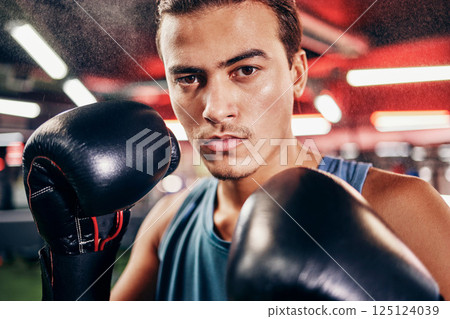 Man, boxing portrait and mma training for sports health fitness in gym. Healthy exercise workout, focus boxer face and hands ready with boxing gloves for fist fight competition in boxing studio 125124039