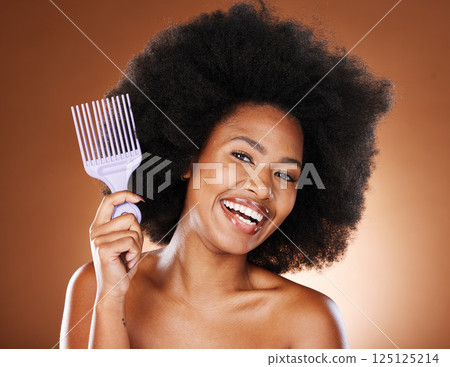 Beauty, hair and afro and black woman and comb for self care, natural and freedom. Happy, smile and untangling with portrait of African girl model and curly hair for luxury and confidence 125125214