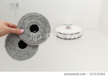 Vacuum cleaner on white glass ceramic tile floor 125125881