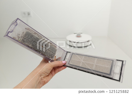 Vacuum cleaner on white glass ceramic tile floor 125125882