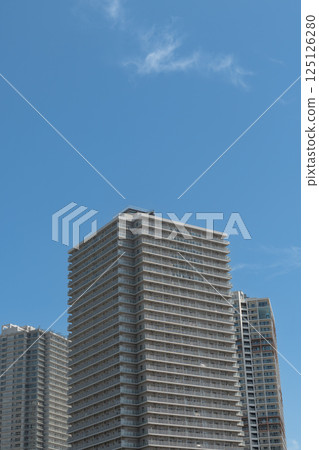 High-rise apartment shining in the blue sky 125126280