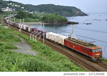 EF510 freight train running along the coast 125126488