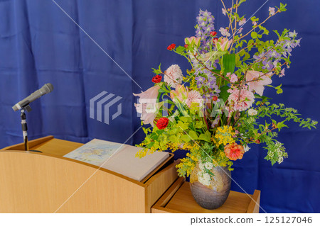 Graduation ceremony podium flowers 125127046