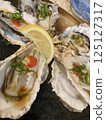 Oysters lined up with shells 125127317