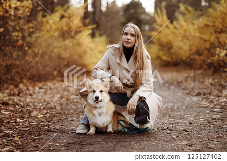 Woman with Corgi in Autumn Park Woman with Corgi in Autumn Park 125127402