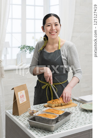 Woman making rice flour pound cake in the kitchen Woman making rice flour pound cake in the kitchen 125127419