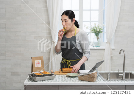 Woman making rice flour pound cake in the kitchen Woman making rice flour pound cake in the kitchen 125127421