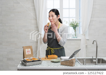 Woman making rice flour pound cake in the kitchen Woman making rice flour pound cake in the kitchen 125127422