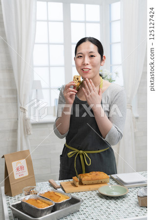 Woman making rice flour pound cake in the kitchen Woman making rice flour pound cake in the kitchen 125127424