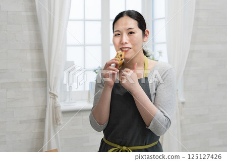 Woman making rice flour pound cake in the kitchen Woman making rice flour pound cake in the kitchen 125127426