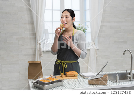 Woman making pound cake in the kitchen Woman making pound cake in the kitchen 125127428