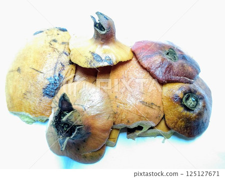 A picture of pomegranate rinds isolated on a white background A picture of pomegranate rinds isolated on a white background 125127671