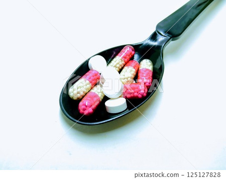 A picture of red and white capsules isolated on white background 125127828