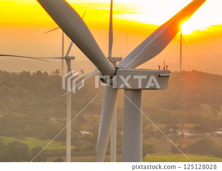 Wind farm field and sunset sky. Wind power. Sustainable, renewable energy. Wind turbines generate electricity. Sustainable development. Green technology for energy sustainability. Eco-friendly energy. 125128028