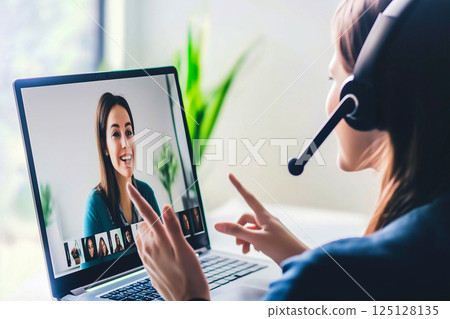 Businesswoman wearing a headset and holding a remote meeting 125128135