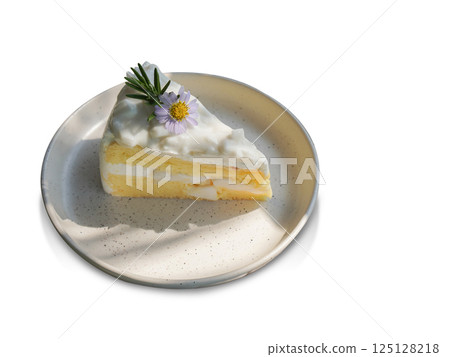 top view Coconut cake decorated with flowers and green leaves on a ceramic plate on white background, fruit, food, copy space 125128218