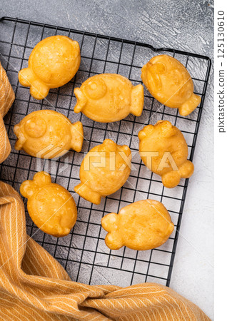 Korean pancake Bungeoppang, Fish shaped Waffle with sweet red bean filling. white background. top view Korean pancake Bungeoppang, Fish shaped Waffle with sweet red bean filling. white background. top view 125130610