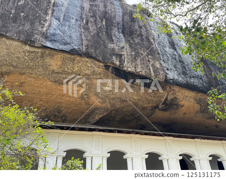 Dambulla Cave Temple corridor and upper rock, with cuttings, World Heritage Site Dambulla Cave Temple corridor and upper rock, with cuttings, World Heritage Site 125131175