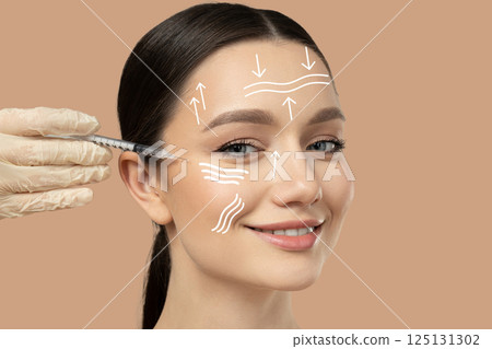 Botox. Skin Care. A girl gets a botox injection, on a light background. 125131302