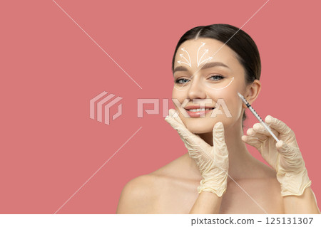 Botox. Skin Care. A girl gets a botox injection, on a light background. 125131307
