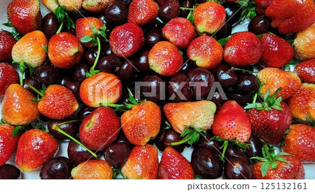 Fresh Strawberries and Cherries Displayed in Vibrant Array Fresh Strawberries and Cherries Displayed in Vibrant Array 125132161