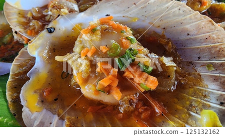 Freshly Cooked Scallops with Colorful Vegetables on a Shell Freshly Cooked Scallops with Colorful Vegetables on a Shell 125132162