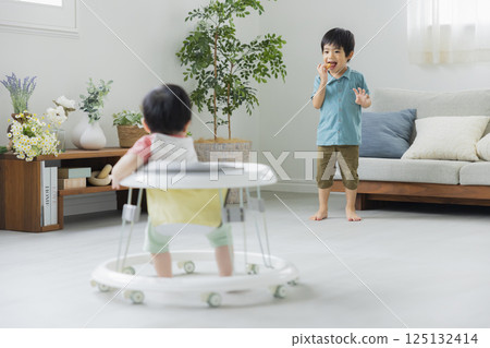 Baby walking on a walker 125132414