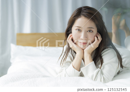 A woman lying on the bed 125132545