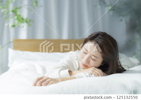 A woman lying on the bed A woman lying on the bed 125132550