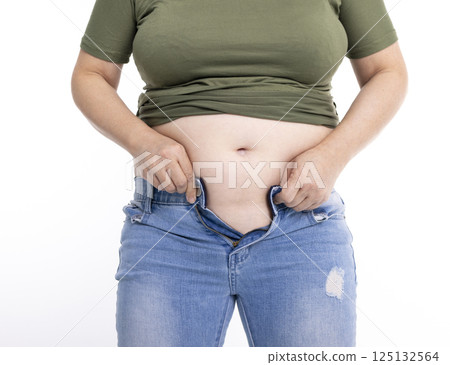 Close up of overweight young woman with fat belly 125132564