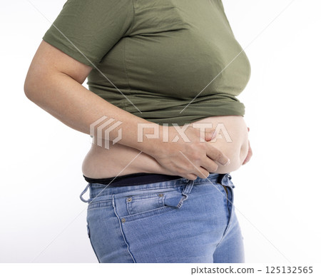 Close up of overweight young woman with fat belly 125132565