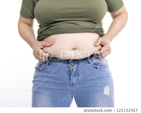 Close up of overweight young woman with fat belly 125132567