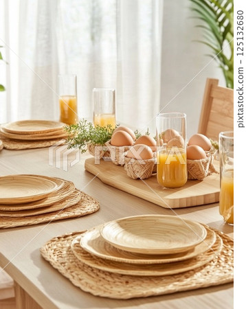 Easter table decorated with woven chargers, Easter eggs, fresh flowers, modern cottedgecore interior 125132680