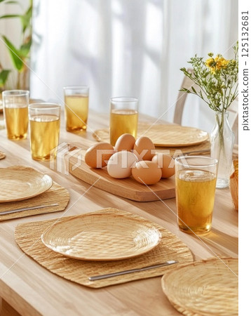 Easter breakfast Natural sunlight, soft shadows, woven chargers, plates, wooden tray, Easter eggs Easter breakfast Natural sunlight, soft shadows, woven chargers, plates, wooden tray, Easter eggs 125132681