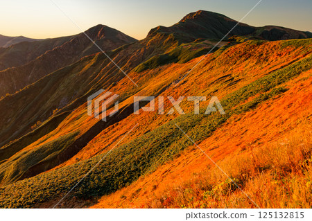 Mount Kitamata at sunrise as seen from Monnai hut in the Iide mountain range Mount Kitamata at sunrise as seen from Monnai hut in the Iide mountain range 125132815