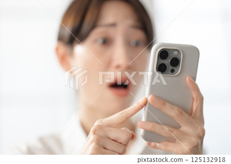 A woman watching smartphone A woman watching smartphone 125132918