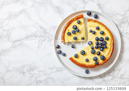 Cheesecake with blueberries sliced on a plate 125133609