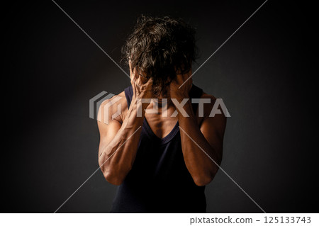 Asian man holds his face with both hands in stress and depression. Asian man holds his face with both hands in stress and depression. 125133743