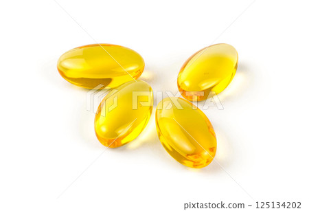 Golden oval soft gel capsules on white surface, omega 3 fish oil supplement for daily nutrition, energy, beauty, and health care Golden oval soft gel capsules on white surface, omega 3 fish oil supplement for daily nutrition, energy, beauty, and health care 125134202